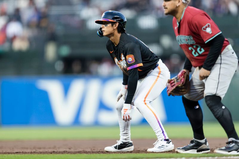 May 13, 2025; San Francisco, California, USA; San Francisco Giants center fielder Jung Hoo Lee (51) leads off first base in front of Arizona Diamondbacks first baseman Josh Naylor (22) during the third inning at Oracle Park. Mandatory Credit: John Hefti-Imagn Images