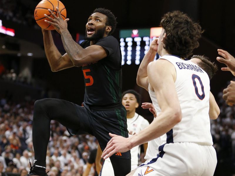 Feb 5, 2024; Charlottesville, Virginia, USA; Miami (Fl) Hurricanes guard Wooga Poplar (5) shoots the ball past Virginia Cavaliers guard Taine Murray (10) and Cavaliers forward Blake Buchanan (0) during the first half at John Paul Jones Arena. Mandatory Credit: Amber Searls-USA TODAY Sports