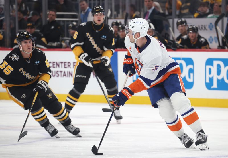 Mar 18, 2025; Pittsburgh, Pennsylvania, USA;  New York Islanders defenseman Adam Pelech (3) skates with the puck against Pittsburgh Penguins center Noel Acciari (55) during the third period at PPG Paints Arena. Mandatory Credit: Charles LeClaire-Imagn Images