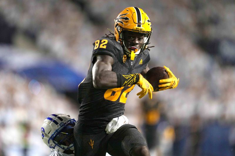 Sep 18, 2021; Provo, Utah, USA;  Arizona State Sun Devils wide receiver Andre Johnson (82) runs with the ball while pursued by BYU Cougars defensive back Isaiah Herron (11) on a 58-yard reception in the first quarter at LaVell Edwards Stadium. Mandatory Credit: Kirby Lee-USA TODAY Sports