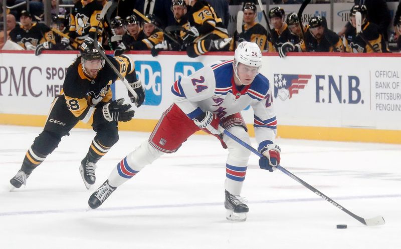 Oct 9, 2024; Pittsburgh, Pennsylvania, USA;  New York Rangers right wing Kaapo Kakko (24) skates up ice on a breakaway as Pittsburgh Penguins defenseman Kris Letang (58) chases during the second period at PPG Paints Arena. Mandatory Credit: Charles LeClaire-Imagn Images