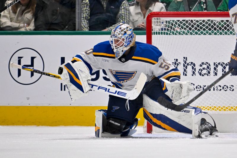 Dec 14, 2024; Dallas, Texas, USA; St. Louis Blues goaltender Jordan Binnington (50) stops a shot by the Dallas Stars during the first period at American Airlines Center. Mandatory Credit: Jerome Miron-Imagn Images