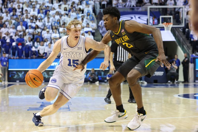 Feb 20, 2024; Provo, Utah, USA; Brigham Young Cougars guard Richie Saunders (15) drives against Baylor Bears center Yves Missi (21) during the second half at Marriott Center. Mandatory Credit: Rob Gray-USA TODAY Sports