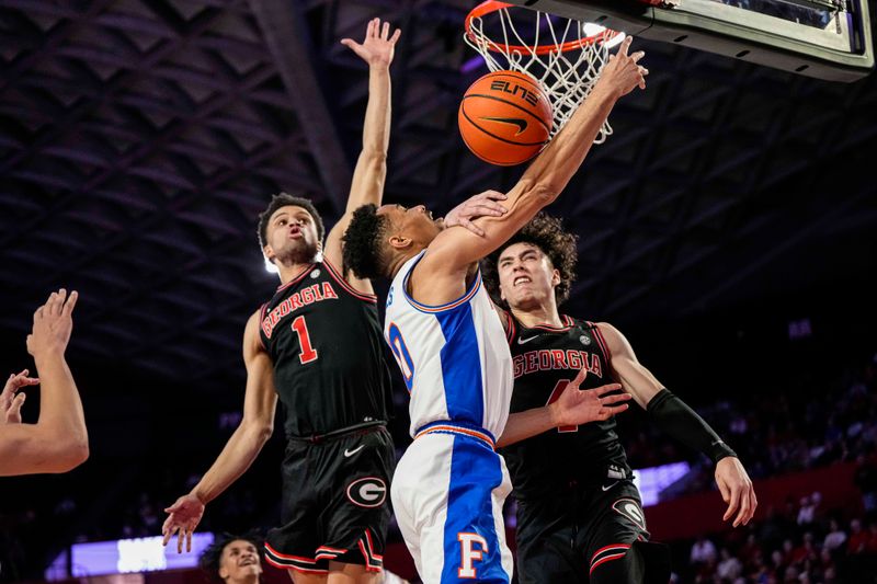 Feb 28, 2023; Athens, Georgia, USA; Florida Gators guard Trey Bonham (2) is defended under the basket by Georgia Bulldogs guard Jusaun Holt (4) and guard Jabri Abdur-Rahim (1) during the first half at Stegeman Coliseum. Mandatory Credit: Dale Zanine-USA TODAY Sports