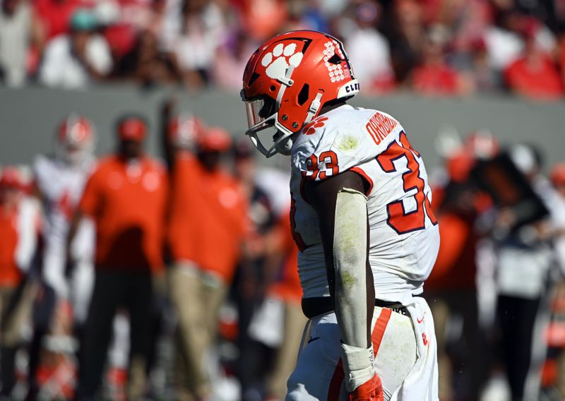 Oct 28, 2023; Raleigh, North Carolina, USA; Clemson Tigers defensive tackle Ruke Orhorhoro (33) reacts after a sack during the first half against the North Carolina State Wolfpack at Carter-Finley Stadium. Mandatory Credit: Rob Kinnan-USA TODAY Sports