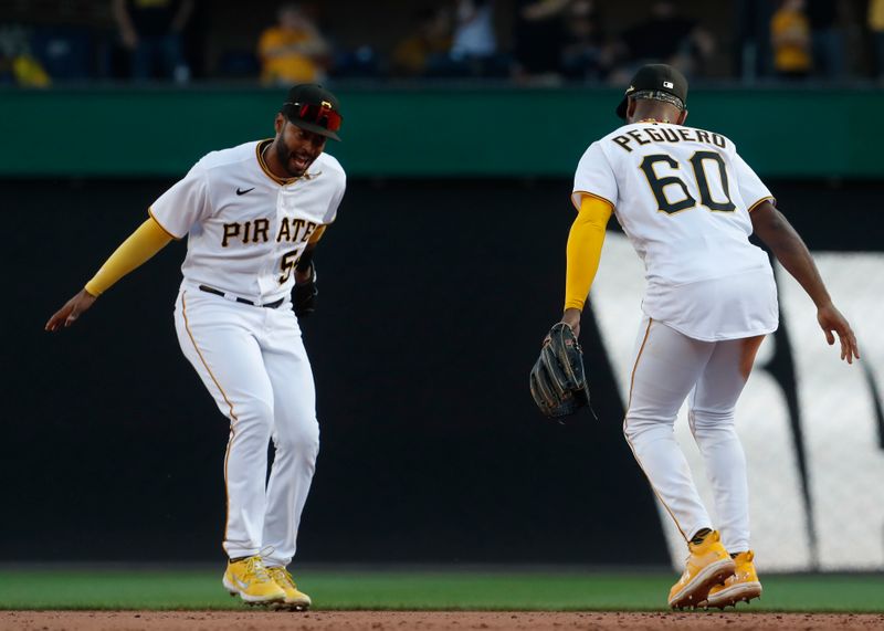 Oct 1, 2023; Pittsburgh, Pennsylvania, USA;  Pittsburgh Pirates right fielder Joshua Palacios (54) and shortstop Liover Peguero (60) celebrate after defeating the Miami Marlins at PNC Park. Pittsburgh won 3-0. Mandatory Credit: Charles LeClaire-USA TODAY Sports