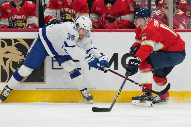 Apr 29, 2024; Sunrise, Florida, USA; Tampa Bay Lightning left wing Brandon Hagel (38) battles for possession with Florida Panthers right wing Vladimir Tarasenko (10) during the first period in game five of the first round of the 2024 Stanley Cup Playoffs at Amerant Bank Arena. Mandatory Credit: Jim Rassol-USA TODAY Sports