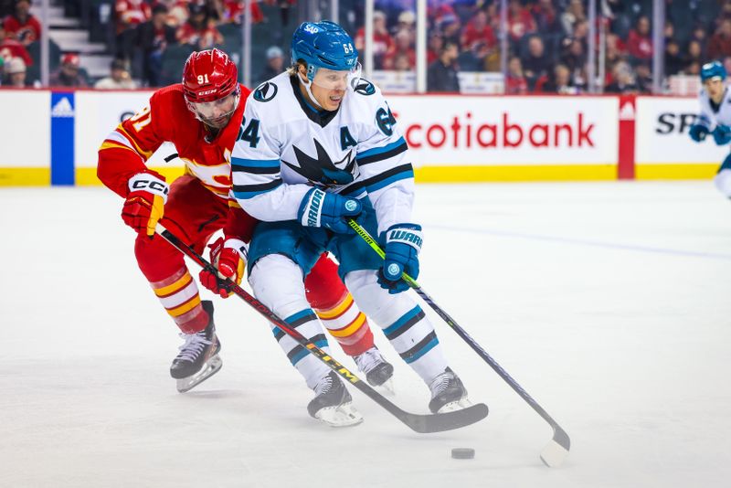 Apr 18, 2024; Calgary, Alberta, CAN; San Jose Sharks center Mikael Granlund (64) and Calgary Flames center Nazem Kadri (91) battles for the puck during the third period at Scotiabank Saddledome. Mandatory Credit: Sergei Belski-USA TODAY Sports