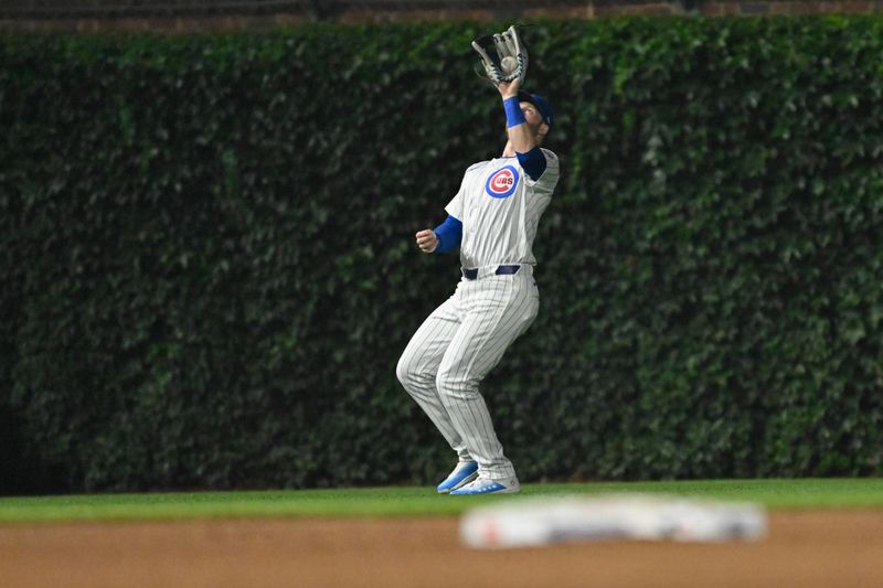 Jul 23, 2024; Chicago, Illinois, USA;  Chicago Cubs outfielder Mike Tauchman (40) catches a fly ball hit by Milwaukee Brewers outfielder Jackson Chourio (11) during the fifth inning at Wrigley Field. Mandatory Credit: Matt Marton-USA TODAY Sports