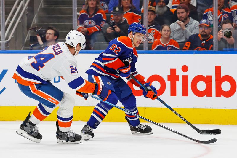 Nov 12, 2024; Edmonton, Alberta, CAN; Edmonton Oilers forward Vasily Podkolzin (92) looks to make a pass in front of New York Islanders defensemen Scott Mayfield (24) during the first period at Rogers Place. Mandatory Credit: Perry Nelson-Imagn Images