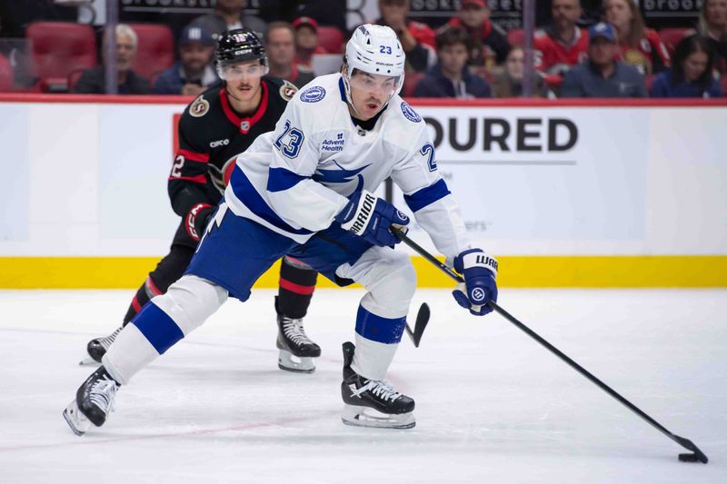 Oct 19, 2024; Ottawa, Ontario, CAN; Tampa Bay Lightning center Michael Eyssimont (23) skates with the puck in front of Ottawa Senators center Shane Pinto (12) in the second period at the Canadian Tire Centre. Mandatory Credit: Marc DesRosiers-Imagn Images