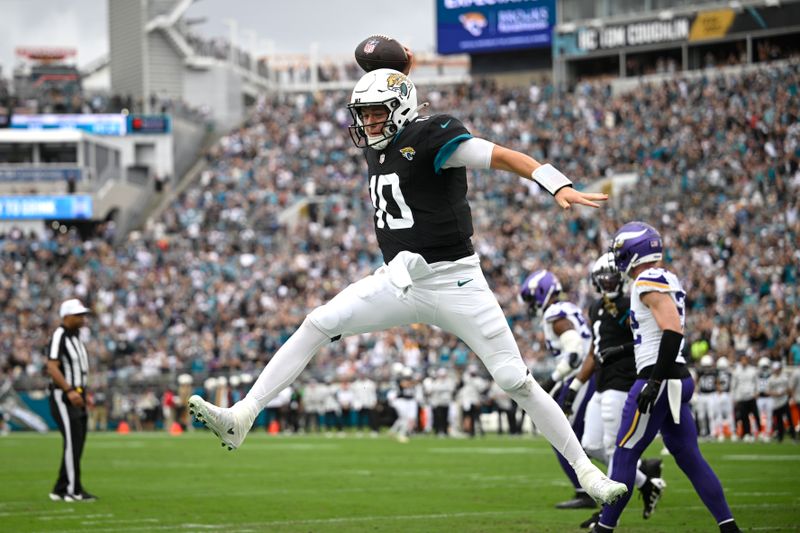 Jacksonville Jaguars quarterback Mac Jones (10) celebrates after running for a 1-yard touchdown during the first half of an NFL football game against the Minnesota Vikings, Sunday, Nov. 10, 2024, in Jacksonville, Fla. (AP Photo/Phelan M. Ebenhack)