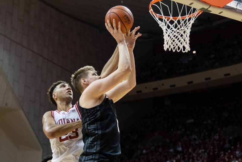 Jan 22, 2023; Bloomington, Indiana, USA; Michigan State Spartans forward Jaxon Kohler (0) shoots the ball while Indiana Hoosiers forward Trayce Jackson-Davis (23) defends in the second half at Simon Skjodt Assembly Hall. Mandatory Credit: Trevor Ruszkowski-USA TODAY Sports