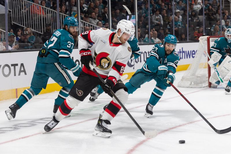 Nov 22, 2025; San Jose, California, USA;  San Jose Sharks center Barclay Goodrow (23) reaches for the puck during the third period against Ottawa Senators center Lars Eller (89) at SAP Center at San Jose. Mandatory Credit: Stan Szeto-Imagn Images