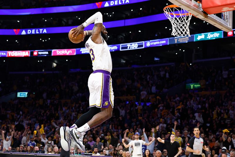 LOS ANGELES, CALIFORNIA - APRIL 27:  LeBron James #23 of the Los Angeles Lakers makes the slam dunk against the Denver Nuggets in the second half during game four of the Western Conference First Round Playoffs at Crypto.com Arena on April 27, 2024 in Los Angeles, California.  NOTE TO USER: User expressly acknowledges and agrees that, by downloading and/or using this photograph, user is consenting to the terms and conditions of the Getty Images License Agreement. (Photo by Ronald Martinez/Getty Images)