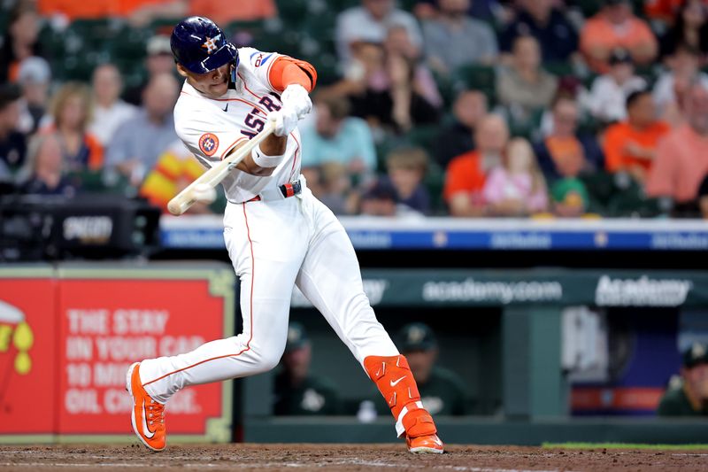 May 28, 2025; Houston, Texas, USA; Houston Astros right fielder Cam Smith (11) hits an RBI double to right field against the Athletics during the fourth inning at Daikin Park. Mandatory Credit: Erik Williams-Imagn Images