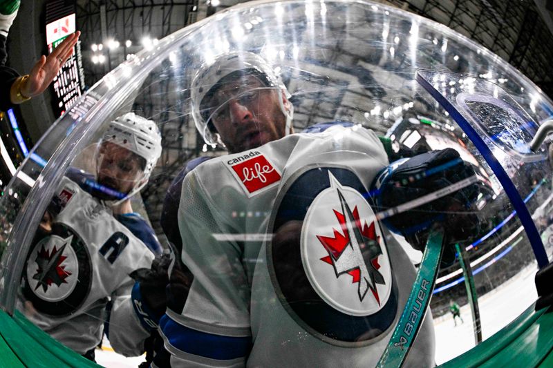 May 11, 2025; Dallas, Texas, USA; Winnipeg Jets defenseman Neal Pionk (4) and center Gabriel Vilardi (13) battles for control of the puck during the second period against the Dallas Stars in game three of the second round of the 2025 Stanley Cup Playoffs at American Airlines Center. Mandatory Credit: Jerome Miron-Imagn Images