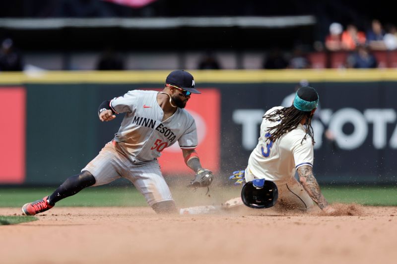 Jun 30, 2024; Seattle, Washington, USA; Seattle Mariners shortstop J.P. Crawford (3) steals second before the tag from Minnesota Twins shortstop Willi Castro (50) during the sixth inning at T-Mobile Park. Mandatory Credit: John Froschauer-USA TODAY Sports