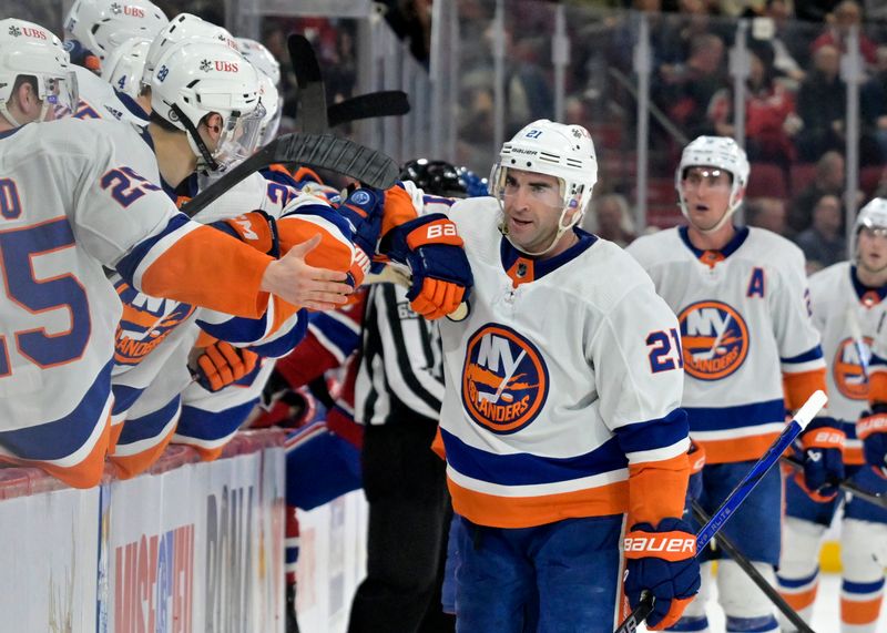 Jan 25, 2024; Montreal, Quebec, CAN; New York Islanders forward Kyle Palmieri (21) celebrates with teammates after scoring a goal against the Montreal Canadiens during the third period at the Bell Centre. Mandatory Credit: Eric Bolte-USA TODAY Sports