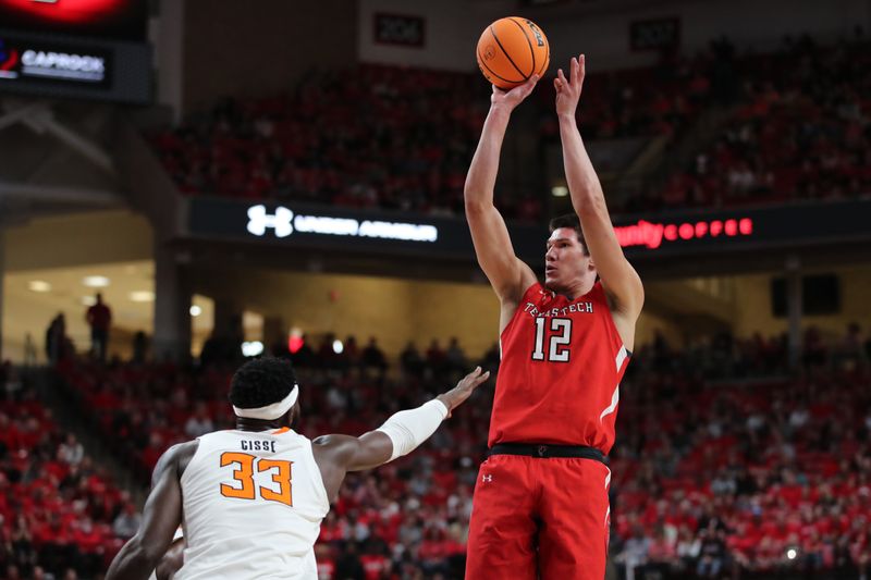 Mar 4, 2023; Lubbock, Texas, USA;  Texas Tech Red Raiders forward Daniel Batcho (12) shoots over Oklahoma State Cowboys forward Moussa Cisse (33) in the first half at United Supermarkets Arena. Mandatory Credit: Michael C. Johnson-USA TODAY Sports