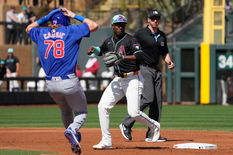 Mar 8, 2024; Salt River Pima-Maricopa, Arizona, USA; Arizona Diamondbacks shortstop Geraldo Perdomo (2) fakes out Chicago Cubs left fielder Owen Caissie (78) in the third inning at Salt River Fields at Talking Stick. Mandatory Credit: Rick Scuteri-USA TODAY Sports