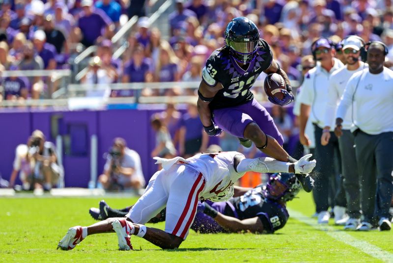 Oct 1, 2022; Fort Worth, Texas, USA;  TCU Horned Frogs running back Kendre Miller (33) hurdles Oklahoma Sooners defensive back Justin Harrington (37) during the first half at Amon G. Carter Stadium. Mandatory Credit: Kevin Jairaj-USA TODAY Sports