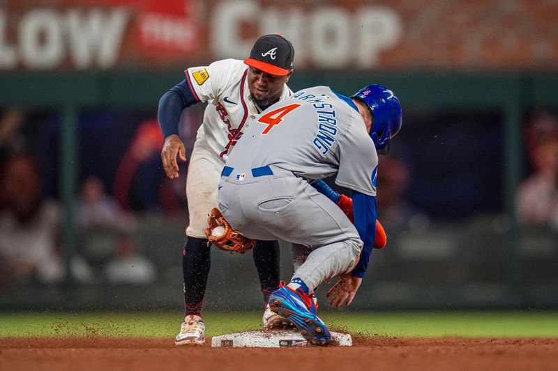 Sep 10, 2025; Cumberland, Georgia, USA; Atlanta Braves second baseman Ozzie Albies (1) forces out Chicago Cubs center fielder Pete Crow-Armstrong (4) during the ninth inning at Truist Park. Mandatory Credit: Dale Zanine-Imagn Images
