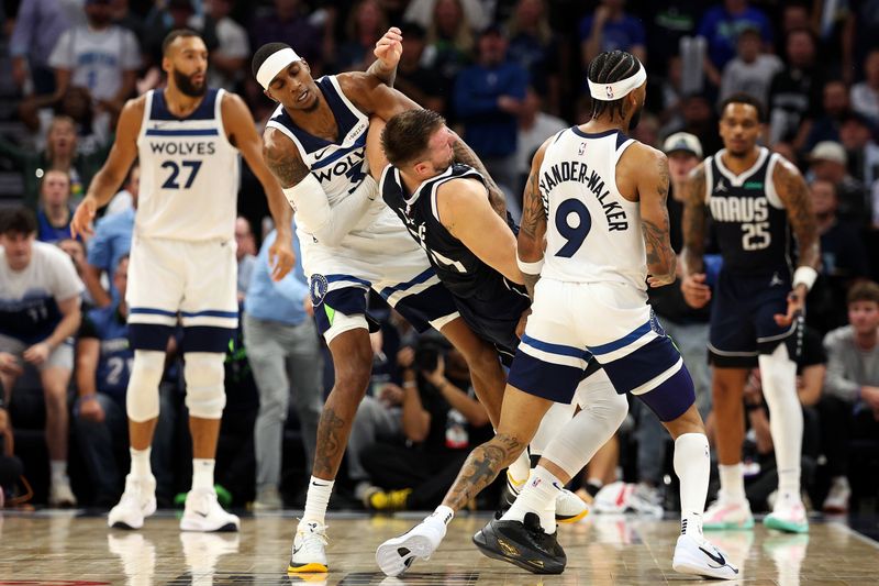 MINNEAPOLIS, MINNESOTA - OCTOBER 29: Jaden McDaniels #3 of the Minnesota Timberwolves intentionally fouls Luka Doncic #77 of the Dallas Mavericks in the fourth quarter at Target Center on October 29, 2024 in Minneapolis, Minnesota. The Mavericks defeated the Timberwolves 120-114. NOTE TO USER: User expressly acknowledges and agrees that, by downloading and or using this photograph, User is consenting to the terms and conditions of the Getty Images License Agreement. (Photo by David Berding/Getty Images)