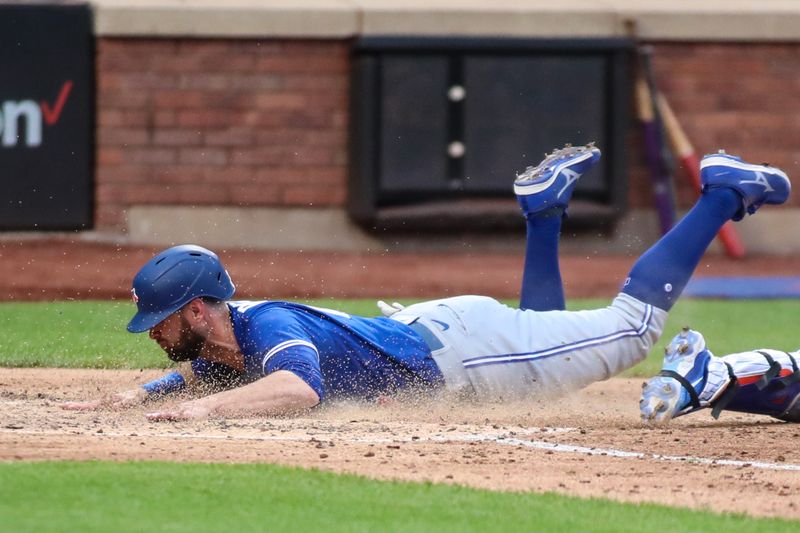 Jun 3, 2023; New York City, New York, USA;  Toronto Blue Jays designated hitter Brandon Belt (13) slides safely to score the tying run in the sixth inning against the New York Mets at Citi Field. Mandatory Credit: Wendell Cruz-USA TODAY Sports