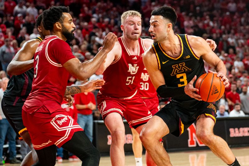 Feb 25, 2024; Lincoln, Nebraska, USA; Minnesota Golden Gophers forward Dawson Garcia (3) drives against Nebraska Cornhuskers forward Rienk Mast (51) and guard Brice Williams (3) during the second half at Pinnacle Bank Arena. Mandatory Credit: Dylan Widger-USA TODAY Sports