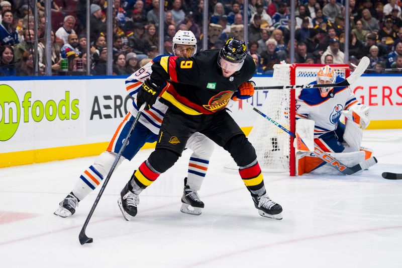 Nov 6, 2023; Vancouver, British Columbia, CAN; Edmonton Oilers forward Connor McDavid (97) battles with Vancouver Canucks forward J.T. Miller (9) in the third period at Rogers Arena. Mandatory Credit: Bob Frid-USA TODAY Sports