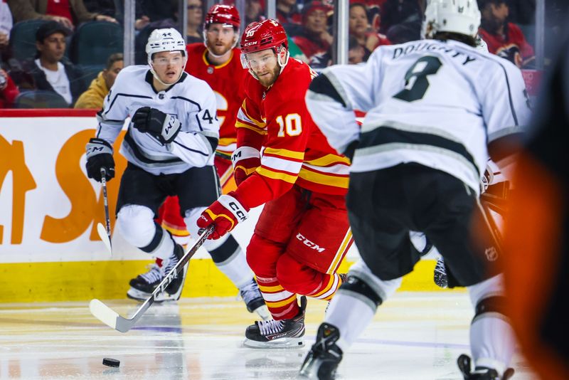 Mar 28, 2023; Calgary, Alberta, CAN; Calgary Flames center Jonathan Huberdeau (10) skates with the puck against the Los Angeles Kings during the second period at Scotiabank Saddledome. Mandatory Credit: Sergei Belski-USA TODAY Sports