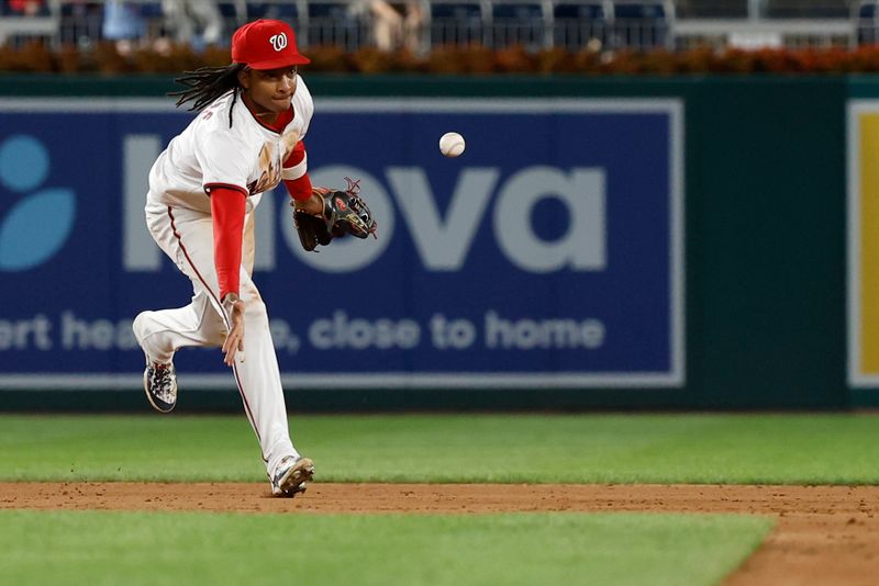 Aug 20, 2024; Washington, District of Columbia, USA; Washington Nationals shortstop CJ Abrams (5) tosses a fielded ground ball hit by Colorado Rockies outfielder Brenton Doyle (not pictured) to second base to begin an inning ending double play during the ninth inningat Nationals Park. Mandatory Credit: Geoff Burke-USA TODAY Sports