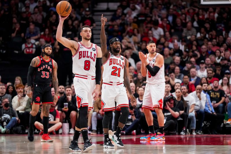 TORONTO, ON - APRIL 12: Zach LaVine #8 and Patrick Beverley #21 of the Chicago Bulls react against the Toronto Raptors during the 2023 Play-In Tournament at the Scotiabank Arena on April 12, 2023 in Toronto, Ontario, Canada. NOTE TO USER: User expressly acknowledges and agrees that, by downloading and/or using this Photograph, user is consenting to the terms and conditions of the Getty Images License Agreement. (Photo by Andrew Lahodynskyj/Getty Images)