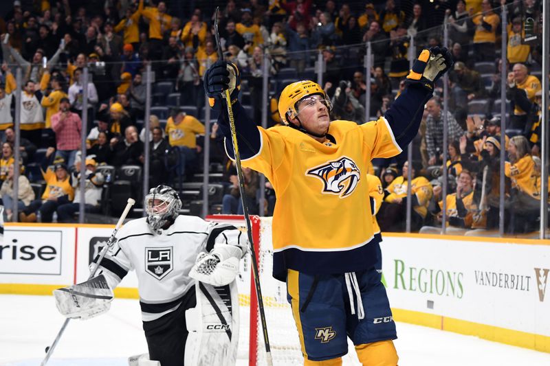 Jan 31, 2024; Nashville, Tennessee, USA; Nashville Predators center Philip Tomasino (26) celebrates after a goal against Los Angeles Kings goaltender David Rittich (31) during the third period at Bridgestone Arena. Mandatory Credit: Christopher Hanewinckel-USA TODAY Sports