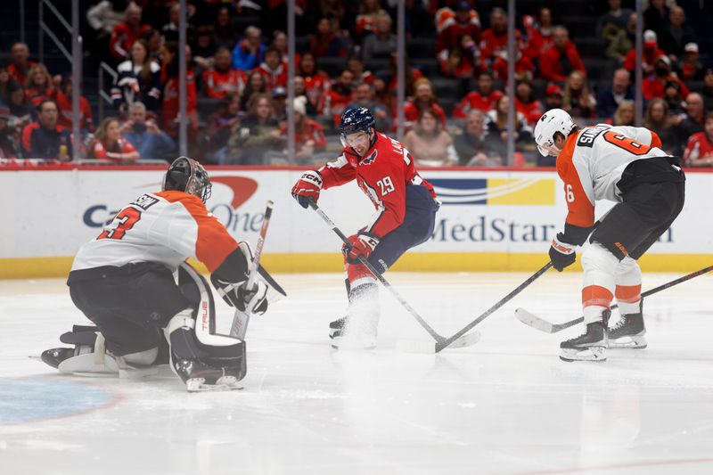 Mar 1, 2024; Washington, District of Columbia, USA; Washington Capitals center Hendrix Lapierre (29) shoots the puck on Philadelphia Flyers goaltender Samuel Ersson (33) as Flyers defenseman Travis Sanheim (6) defends in the third period at Capital One Arena. Mandatory Credit: Geoff Burke-USA TODAY Sports