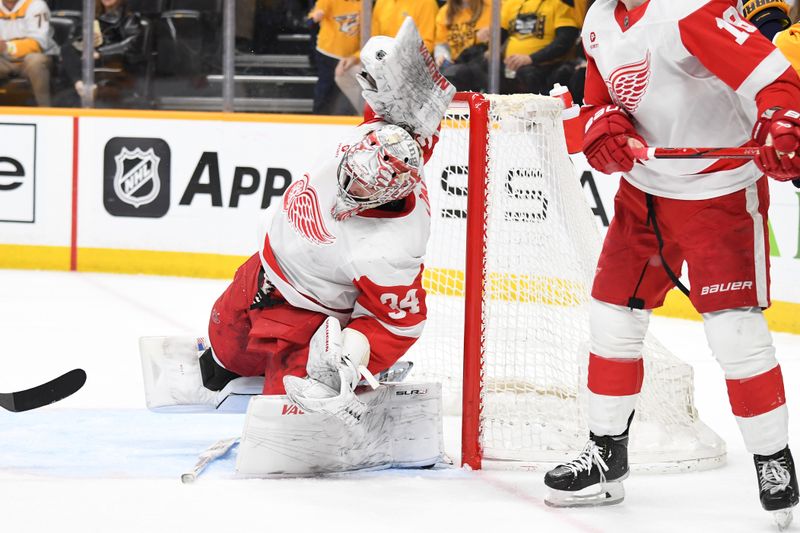 Mar 23, 2024; Nashville, Tennessee, USA; Detroit Red Wings goaltender Alex Lyon (34) makes a save during the third period against the Nashville Predators at Bridgestone Arena. Mandatory Credit: Christopher Hanewinckel-USA TODAY Sports