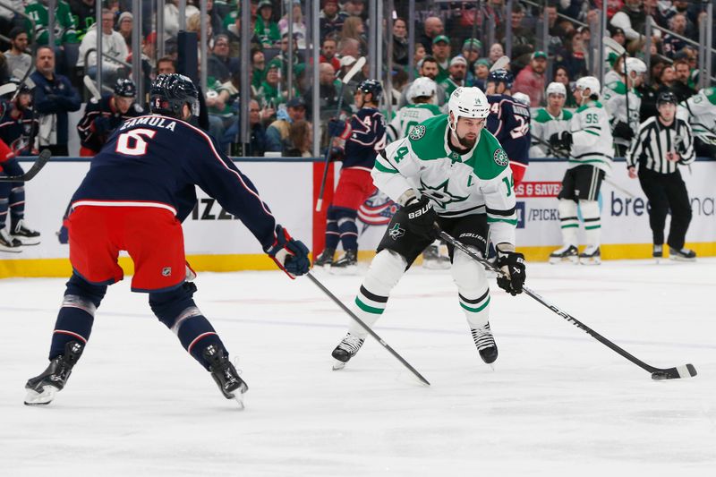 Jan 22, 2026; Columbus, Ohio, USA; Dallas Stars left wing Jamie Benn (14) carries the puck as Columbus Blue Jackets defenseman Egor Zamula (6) defends during the first period at Nationwide Arena. Mandatory Credit: Russell LaBounty-Imagn Images