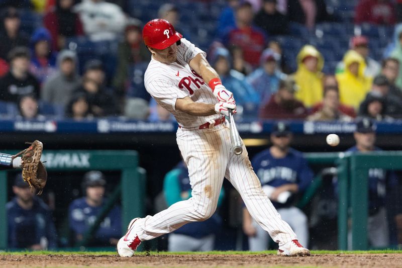 Apr 26, 2023; Philadelphia, Pennsylvania, USA; Philadelphia Phillies catcher J.T. Realmuto (10) hits an RBI single during the eighth inning against the Seattle Mariners at Citizens Bank Park. Mandatory Credit: Bill Streicher-USA TODAY Sports