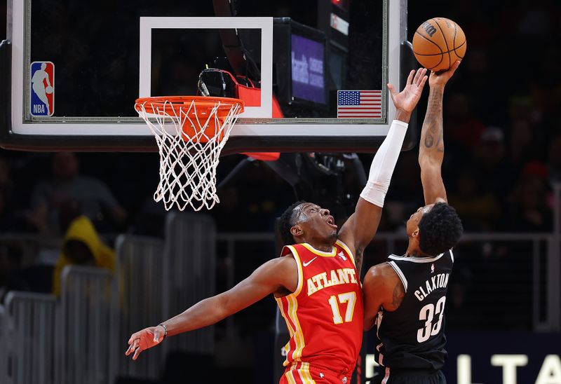 ATLANTA, GEORGIA - DECEMBER 06:  Onyeka Okongwu #17 of the Atlanta Hawks defends against Nic Claxton #33 of the Brooklyn Nets during the second quarter at State Farm Arena on December 06, 2023 in Atlanta, Georgia.  NOTE TO USER: User expressly acknowledges and agrees that, by downloading and/or using this photograph, user is consenting to the terms and conditions of the Getty Images License Agreement.  (Photo by Kevin C. Cox/Getty Images)