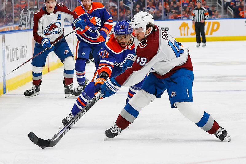 Mar 16, 2024; Edmonton, Alberta, CAN; Colorado Avalanche defensemen Sam Girard (49) and Edmonton Oilers forward Evander Kane (91) battle for a loose puck during the third period at Rogers Place. Mandatory Credit: Perry Nelson-USA TODAY Sports