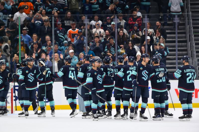 Oct 17, 2024; Seattle, Washington, USA; The Seattle Kraken celebrate defeating the Philadelphia Flyers at Climate Pledge Arena. Mandatory Credit: Steven Bisig-Imagn Images