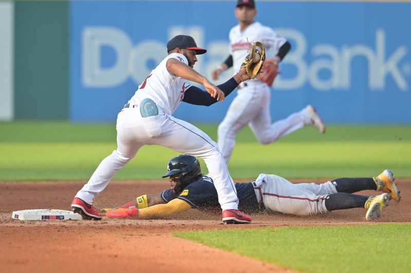 Jul 3, 2023; Cleveland, Ohio, USA; Atlanta Braves right fielder Ronald Acuna Jr. (13) steals second as Cleveland Guardians shortstop Amed Rosario (1) is late with the tag during the third inning at Progressive Field. Mandatory Credit: Ken Blaze-USA TODAY Sports