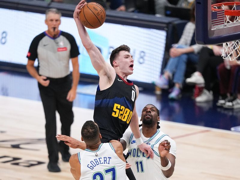 DENVER, CO - MAY 19: Christian Braun #0 of the Denver Nuggets drives to the basket during the game  against the Minnesota Timberwolves during Round 2 Game 7 of the 2024 NBA Playoffs on May 19, 2024 at the Ball Arena in Denver, Colorado. NOTE TO USER: User expressly acknowledges and agrees that, by downloading and/or using this Photograph, user is consenting to the terms and conditions of the Getty Images License Agreement. Mandatory Copyright Notice: Copyright 2023 NBAE (Photo by Bart Young/NBAE via Getty Images)