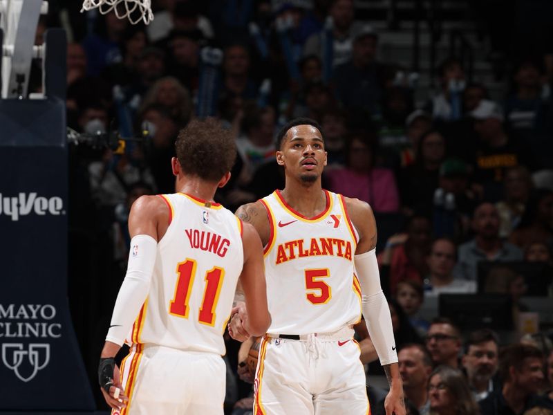 MINNEAPOLIS, MN -  APRIL 12:  Trae Young #11 high fives  Dejounte Murray #5 of the Atlanta Hawks during the game against the Minnesota Timberwolves on April 12, 2024 at Target Center in Minneapolis, Minnesota. NOTE TO USER: User expressly acknowledges and agrees that, by downloading and or using this Photograph, user is consenting to the terms and conditions of the Getty Images License Agreement. Mandatory Copyright Notice: Copyright 2024 NBAE (Photo by David Sherman/NBAE via Getty Images)