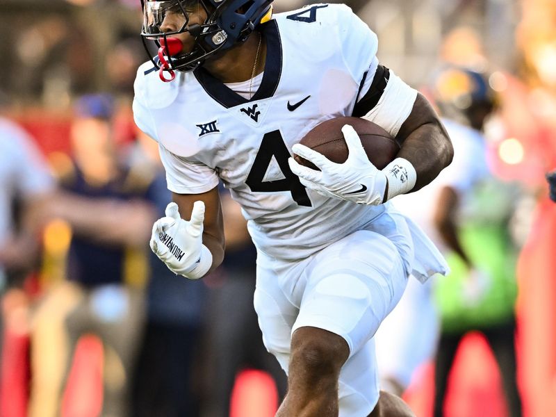 Oct 12, 2023; Houston, Texas, USA; West Virginia Mountaineers running back CJ Donaldson Jr. (4) carries the ball during the first quarter against the Houston Cougars  at TDECU Stadium. Mandatory Credit: Maria Lysaker-USA TODAY Sports