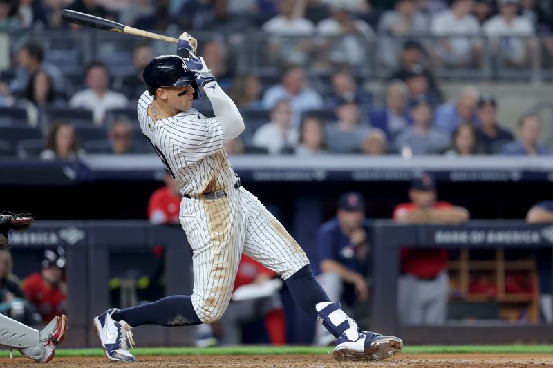 Jun 6, 2025; Bronx, New York, USA; New York Yankees right fielder Aaron Judge (99) follows through on an RBI double against the Boston Red Sox during the fifth inning at Yankee Stadium. Mandatory Credit: Brad Penner-Imagn Images