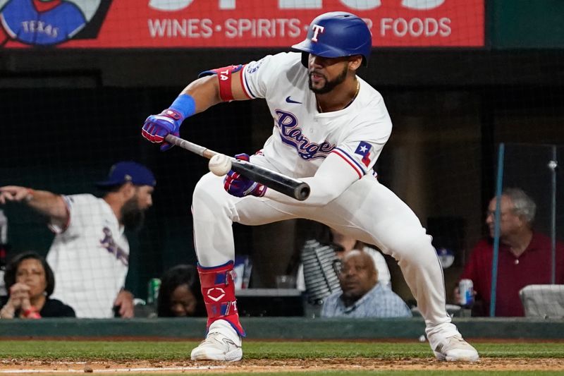 Jul 22, 2024; Arlington, Texas, USA; Texas Rangers center fielder Leody Taveras (3) lays down a sacrifice bunt during the tenth inning against the Chicago White Sox at Globe Life Field. Mandatory Credit: Raymond Carlin III-USA TODAY Sports