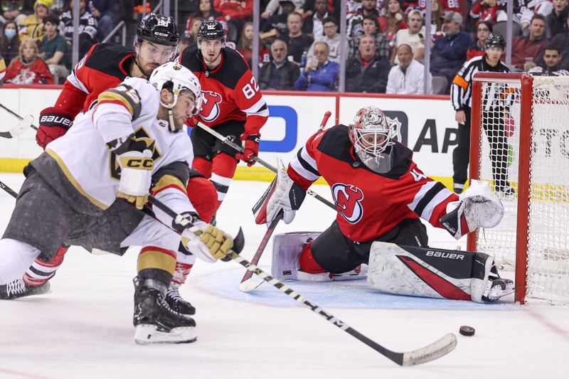 Jan 22, 2024; Newark, New Jersey, USA; Vegas Golden Knights center Paul Cotter (43) reaches for the puck in front of New Jersey Devils goaltender Vitek Vanecek (41) during the second period at Prudential Center. Mandatory Credit: Vincent Carchietta-USA TODAY Sports