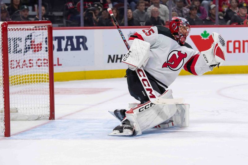 Oct 17, 2024; Ottawa, Ontario, CAN; New Jersey Devils goalie Jacob Markstrom (25) makes a save in the first period against the Ottawa Senators at the Canadian Tire Centre. Mandatory Credit: Marc DesRosiers-Imagn Images